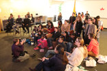 Image of A reporter from the Houston Chronicle, center, documents University of St. Thomas students, faculty, staff and alumni watching Pope Francis make his first public appearance. 