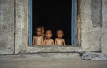Image of Starving children huddled in a window in North Korea. This is typical for those living in the countryside. 