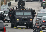 Image of A Swat team sweeps the Watertown area in the hunt for suspect No. 2.