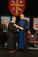 Image of Photo by Gary Fountain
Robert George accepts an honorary degree from University President Dr. Robert Ivany. 