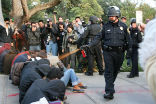 Image of A police officer on the campus of UC Davis in California, a victim of annoyance. 
