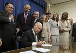 Image of Governor Jerry Brown signing California Assembly Bill 1266 into law. It mandates that restrooms in public schools, from kindergarten through the twelfth grade, no longer be limited to boys or girls, young men or young women.