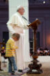 Image of Pope Francis acknowledged the little boy, rubbing his head for a second as the child clings to his side. 