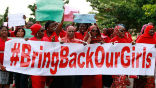 Image of A group of Nigerians holding banners urging the Muslim group Boko Haram to return the more than 200 girls they kidnapped in mid-April.
