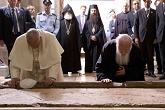 Image of Pope and Patriarch pray in humility at the Stone of Unction at the Holy Sepulcher in Jerusalem. May such humility help to advance the full communion of the Church. 