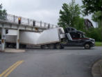 Image of A long island trucker had the top of his semi's trailer sheered off after he hit an overpass that was lower than usual.