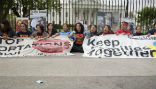 Image of Protestors of U.S. immigration and deportation policy sit with banners outside the White House.
