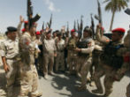 Image of A group of Iraqi security forces celebrate in Baghdad.