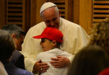 Image of Pope Francis embraces a young student on May 31, 2014 in Paul VI audience hall. 