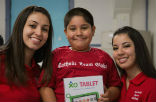 Image of Lucia and Michelle, Catholic Team Global ambassadors, delivered the first batch of new XO tablets to Our Lady of Gaudalupe parish elementary school in Bakersfield, California.