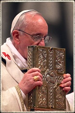 Image of Pope Francis kissing the Book of the Gospels