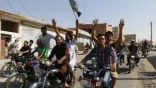 Image of Residents of Raqqa, the capital of the Islamic State, celebrate the capture of a Syrian airbase.