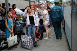 Image of Ukrainian refugees at a Russian train station.