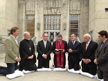 Image of Emergency delegation of pastors prays in front of Houston City Hall before meeting with Mayor Annise Parker