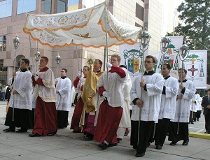 There is also an ancient and beautiful custom in the Latin Rite of the Catholic Church called the Corpus Christi procession. The consecrated Host, the Body of the Lord, is reposed in what is called a monstrance. The term is derived from a Latin phrase which means to show or reveal.  The faithful process the Body of the Lord through the streets surrounding their church buildings. This Eucharistic procession can be a powerful witness to an age which has lost its sense of the sacred.