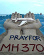 Image of A sand sculpture urging all to pray for MH370.