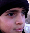 Image of The young boy, no older than 10, appears in new ISIS video beheading a Syrian soldier.