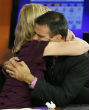 Image of Colleagues hug during the moment of silence for their fallen team members.