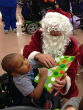 Image of Boy opens gift at the Louisiana Special Education Center (Leigh Guidry).