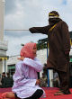 Image of Woman caned for standing too close to a man she was not married to (AFP/Getty Images).