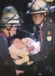 Image of Rescuers discover 8-month-old baby in the rubble of a crumbled building (BBC).