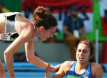 Image of Abbey D'Agostino stopped to help a competitor in the middle of an Olympic race.