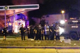 Image of Milwaukee police hold a standoff with protesters following a fatal  police shooting.