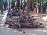Image of Boko Haram soldiers hovering over innocents whom they slaughterd in the name of their 