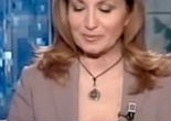 Image of Italian newscaster criticized for wearing crucifix and rosary beads on air.