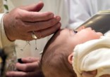 Image of Pope Francis baptized 28 babies (L'Osservatore Romano/Reuters).