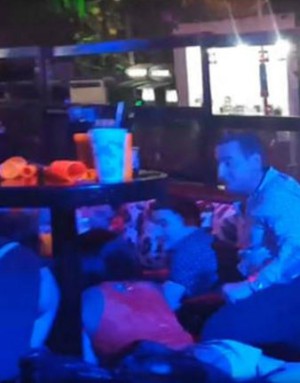 Blue Parrot nightclub patrons huddle under tables as shots ring out (Marcos Vazquez/Twitter).