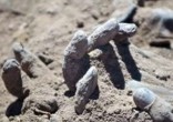 Image of The sight of the bodies dumped in the mass grave brought one soldier to tears.