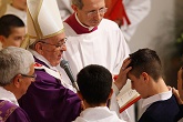 Image of Pope Francis conferring the Sacrament of Confirmation on a young man. 