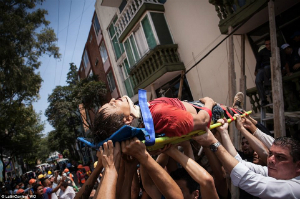 Rescuers move an injured man to safety. Over 800 people were seriously injured. Minor injuries were widespread.