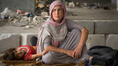 A Yazidi refugee woman with her child. ISIS slaughtered thousands of Yazidi and Christian minorities during their rampage though Syria and Iraq.
