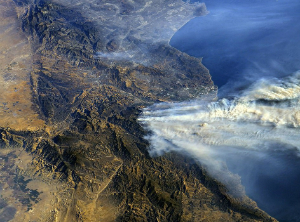 A photo from the International Space Station shows smoke from the fires blowing out to sea.