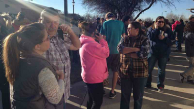 Parents wait anxiously while Aztec High School is evacuated. At least two students died during the incident on Thursday.
