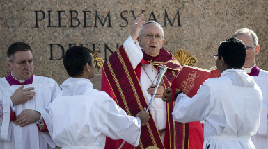 Pope Francis blesses the audience during Palm Sunday Mass.