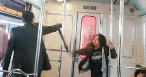 An allegedly possessed woman strikes at a man attempting an exorcism on her.