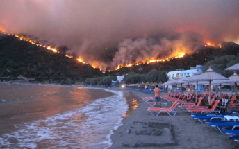 A man takes refuge on a beach in Greece as fires ravage the country.
