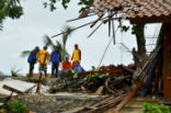 Image of Officials look through the wreckage of damaged buildings in Carita, Indonesia on December 23, 2018. Credit: AFP/Getty Images.