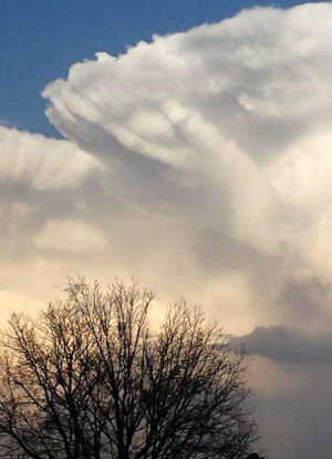 God's hand outlined in the clouds.