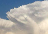 Image of God's hand outlined in the clouds.