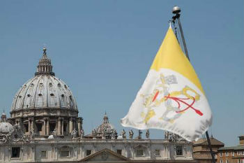 View of St. Peters Basilica and Vatican City flag