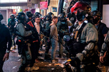 Riot police detain two men after clearing protesters from the Central district in Hong Kong