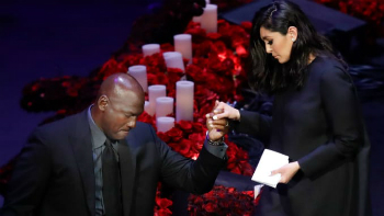Image of Michael Jordan helps Vanessa Bryant off the stage during the emotional tribute to Kobe Bryant at the Staples Center in Los Angeles. 