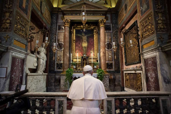 Image of Pope Francis prays before the crucifix of the Church of San Marcello al Corso March 15 2020 
