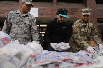 Image of National Guard members hand out food to residents near a one mile radius containment area set up to halt coronavirus March 12 2020 in New Rochelle New York