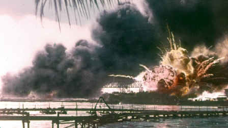 Image of A colorized photo shows the moment the Mahan-class destroyer, USS Shaw (DD-373) exploded after bring attacked by Japanese dive bombers. The bombs detonated in her forward ammunition magazine, causing the explosion. Remarkably, Shaw was repaired and returned to service, earning 11 battle stars during the war. 