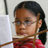 Image of GIRL PLAYS FLUTE DURING MUSIC PROGRAM – Sarah Camarillo, 10, plays the flute during the Viva PATS (Performing Arts Theatre School) program at St. Patrick's Parish in East Chicago, Ind., July 18. The program runs throughout the school year, but is also offered to children in the local community for six weeks during summer. (CNS/Northwest Indiana Catholic)
